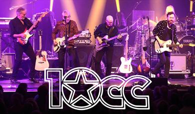 promotional photo of the band 10cc on stage