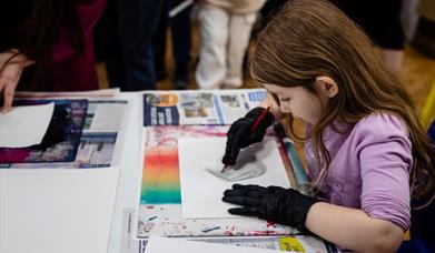 a girl using printing techniques in a art workshop