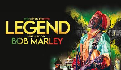 Bob Marley impersonator playing a guitar.