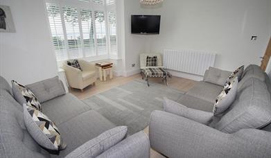 Promenade View living area with sofas and tv