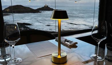 Rok Mumbles dining table with view of lighthouse