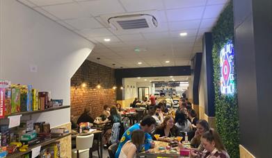 Socialdice interior with people playing board games