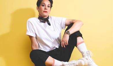 Suzi Ruffell sat down in front of a yellow background
