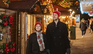 Young couple exploring Swansea Christmas Market