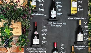 The Wine House bottles of wine displayed on a wall