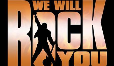 we will rock you written in Orange with a silhouette cut out of a man holding a guitar