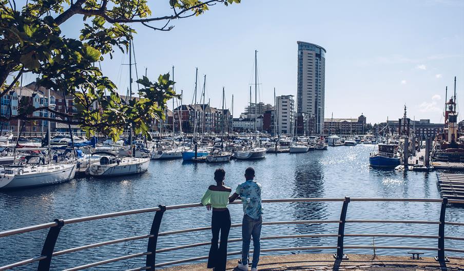 A couple overlooking Swansea Marina.