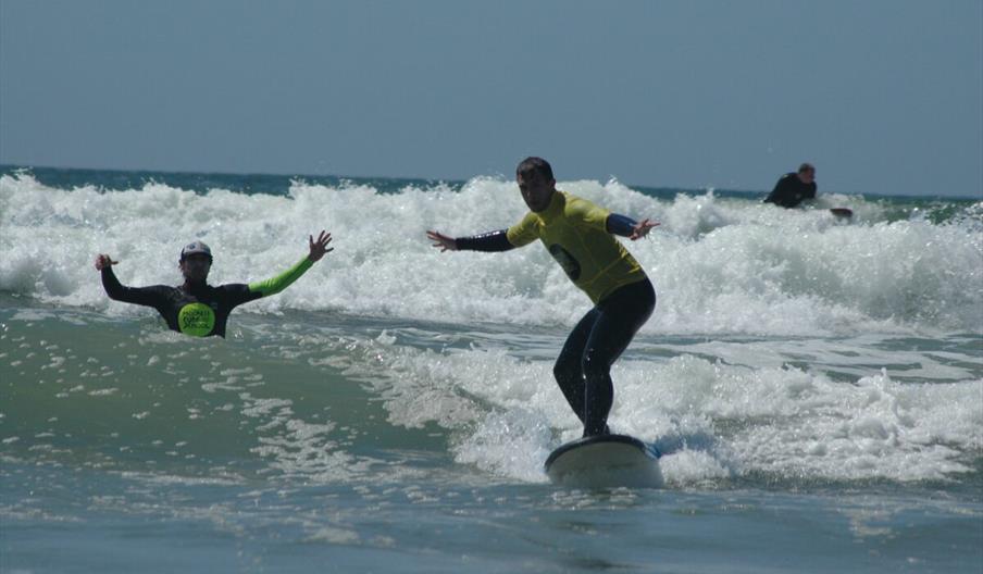 Progress Surf School man learning to swim with instructor