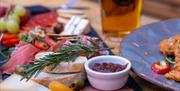 A sharing platter of charcuterie with a Gower Brewery pint