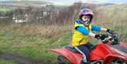 Dulais Valley Quads child on quadbike on hill