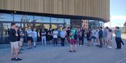 A group of people outside Swansea Arena