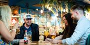 Founders & Co customers with drinks and board games
