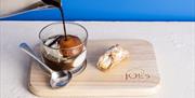 Joes Ice Cream coffee and ice cream with cannoli on a wooden board