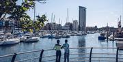 A couple overlooking Swansea Marina.