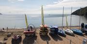 Oxwich Watersports boats and kayaks lined up on beach