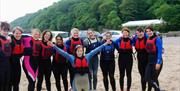 Oxwich Watersports group in wetsuits on beach