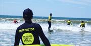 Progress Surf School instructor watching surfing class