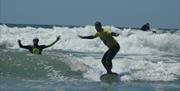 Progress Surf School man learning to swim with instructor