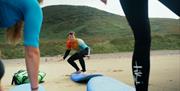 Savage Adventures person learning to surfboard
