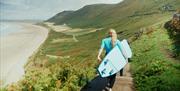 Savage Adventures surfers carrying surf boards