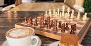 Socialdice chessboard with coffee and cake