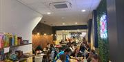 Socialdice interior with people playing board games