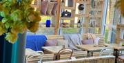 Malthouse interior, wooden seating and hanging plants.