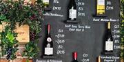 The Wine House bottles of wine displayed on a wall