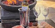 The Wine House firepit with wine and cheesboard