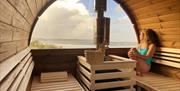 Ty Sawna customer sitting inside sauna pod relaxing