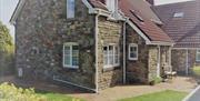 Tyn Cellar Farm Holiday Cottages exterior and garden bench