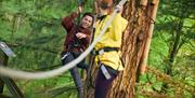Two friends completing a zipline
